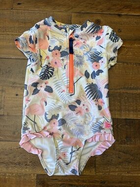Ruffle Butts Short Sleeve One-Piece Rash Guard Swimsuit in Pink Flamingo Print